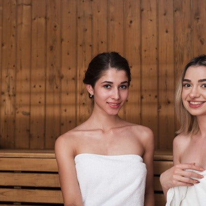 Two women smiling in the sauna